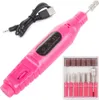A pink electric nail file with a USB charging cable and a set of interchangeable drill bits. Náhled obrázku produktu