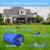 A dog agility course set up in a grassy yard in front of a house. Voir les images du produit