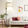 A modern living room scene with a floor lamp, sofa, and artwork. Anteprima dell’immagine prodotto