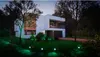 A modern house at night, illuminated by green outdoor lights. Produktbild-Vorschau