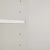 A close-up view of a white shelf attached to a light gray wall with several small holes. Podgląd zdjęcia produktu