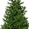 Close-up view of the branches and needles of a green artificial Christmas tree. Podgląd zdjęcia produktu