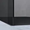 A close-up view of a modern shower enclosure, showing its sleek black frame and clear glass panels against a textured gray wall and a light-colored floor. Anteprima dell’immagine prodotto