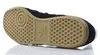 The underside of a black Adidas shoe with a tan sole. Anteprima dell’immagine prodotto
