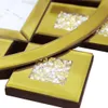 Close-up view of a decorative wall clock with gold accents and embedded crystals. Voir les images du produit