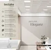 A modern office interior with a ceiling full of LED panels and a wall with marketing text. Náhled obrázku produktu