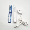 A white electric toothbrush and its accessories are laid out on a white surface. Produktbild-Vorschau