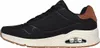 A side view of a black Skechers sneaker with a cream sole and brown accents. Náhľad obrázku produktu