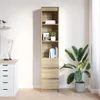 A tall, narrow bookshelf with three drawers at the bottom, placed in a room next to a large potted plant and a desk with a lamp. Podgląd zdjęcia produktu