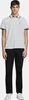 A man is standing and posing for a product shot, wearing a polo shirt and trousers. Produktbild-Vorschau