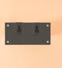 The back of a black solar powered outdoor light fixture with mounting holes. Produktbild-Vorschau