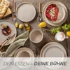 A table setting with plates, cutlery, food, and a coffee cup. Produktbild-Vorschau