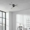 A modern ceiling light fixture with multiple arms, each ending in a light source, mounted on a white ceiling. Produktbild-Vorschau