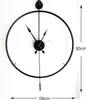 A black metal wall clock with a minimalist design, shown against a white background. Dimensions are indicated by measurement lines and text. Voir les images du produit