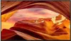 A scenic view of a desert canyon with colorful rock formations and a sunset sky. Produktbild-Vorschau
