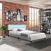 A bedroom setting with a bed, artwork on the wall, and a shelf unit. Náhled obrázku produktu