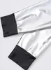 Close-up of the cuffs of two sleeves of a metallic silver jumpsuit with black cuffs. Anteprima dell’immagine prodotto