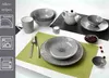 A collection of ceramic tableware with a striped pattern, arranged on a table. Voir les images du produit