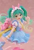 A close-up of a Hatsune Miku figure dressed in a fairy tale-themed outfit, holding a pink Rody toy. Produktbild-Vorschau