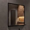 A modern bathroom with a mirror and shelf. Produktbild-Vorschau