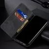 A black flip-style phone case with card slots and a bill compartment, showing a phone screen and some cards and cash. Produktbild-Vorschau
