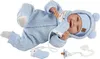 A baby doll lying on its back, wearing a blue outfit and hat, with a pacifier and chain nearby. Produktbild-Vorschau
