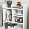 A white shelf unit with various decorative items and books. Podgląd zdjęcia produktu