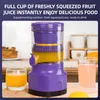 A purple electric juicer is shown with glasses of juice and fruit in the background. Podgląd zdjęcia produktu