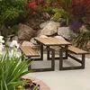 A picnic table with benches is set up outdoors in a garden with rocks and plants. Podgląd zdjęcia produktu