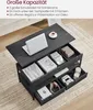 A dark wood coffee table with its top lifted, revealing storage compartments filled with various items like books, a laptop, a cup, game controllers, and headphones. Produktbild-Vorschau
