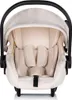A front view of a cream-colored baby car seat with a black handle and a light-colored canopy. Produktbild-Vorschau