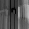 A close-up view of a black highboard with fluted glass doors and black handles. Produktbild-Vorschau