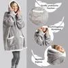 A woman wearing a grey hooded blanket with white trim, with close-up shots highlighting its features. Produktbild-Vorschau