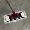A mop with a telescopic handle is shown on a tiled floor. Produktbild-Vorschau