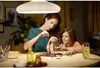 A mother and daughter are sewing a stuffed bunny under a lamp. Anteprima dell’immagine prodotto