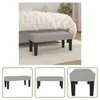 A light gray fabric bench with black legs is placed in front of a bed in a bedroom setting. The bench is the main focus of the image. Náhled obrázku produktu