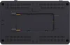 The back of a black electronic device, likely a monitor, is shown. It has a textured surface with ventilation slots and a central rectangular cutout with gold-colored connectors. Produktbild-Vorschau