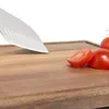 A close-up shot of a wooden cutting board with tomatoes and a knife. Anteprima dell’immagine prodotto