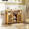 A bathroom vanity cabinet with storage shelves and doors, displaying toiletries and towels. Podgląd zdjęcia produktu