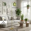 A modern living room with a sofa, coffee table, and plants, featuring a floor lamp. Anteprima dell’immagine prodotto