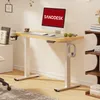 A standing desk with a computer, accessories, and books. Voir les images du produit