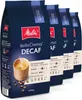 Four bags of Melitta BellaCrema Decaf coffee beans are displayed in a row against a white background. Produktbild-Vorschau