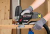 A person is using a cordless jigsaw to cut a piece of wood. Produktbild-Vorschau