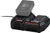 A black battery charger with a gray battery inserted, shown from a three-quarter angle against a white background. Produktbild-Vorschau
