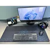 A desk setup with a computer monitor, keyboard, mouse, headphones, and a desk mat. Voir les images du produit