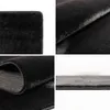 A collage of four close-up images showing different angles and textures of a black rug. Produktbild-Vorschau