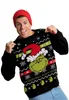 A man wearing a Grinch-themed Christmas sweater and a red beanie, posing for a product shot. Produktbild-Vorschau