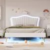 A white upholstered bed with a crown-shaped headboard and LED lighting, set in a child's bedroom. Produktbild-Vorschau