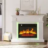 A white electric fireplace with a realistic flame effect and green LED lighting, set in a living room. Produktbild-Vorschau