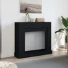 A black fireplace surround is shown in a room with a painting above it and a plant to the side. Voir les images du produit